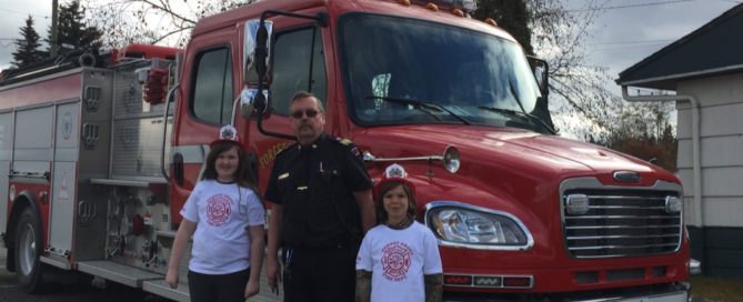 Ruth MacDonald and Kohen Angus from Forest Grove Elementary School awarded fire chief for a day